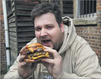  ?? Picture: PAUL CARRACHER ?? DIG IN: Horsham chef Stewart Neighbour tucks into a gourmet burger ahead of the launch of his new Big Boy Burger Co business next week. Mr Neighbour will operate the delivery-only business from the kitchen of Nourish’d Eatery in Roberts Avenue.