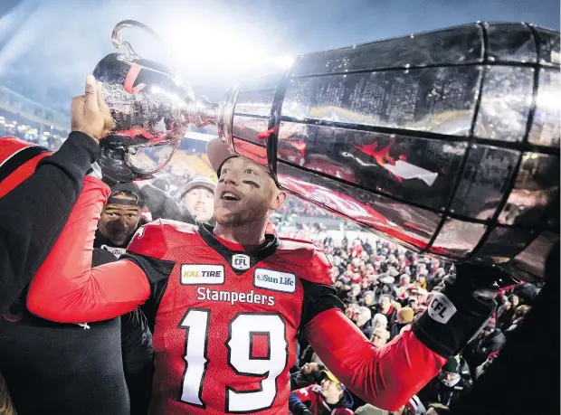  ?? — CP ?? Stamps QB Bo Levi Mitchell hoists the Grey Cup after defeating the Redblacks 27-16 in the 106th Grey Cup in Edmonton on Sunday.