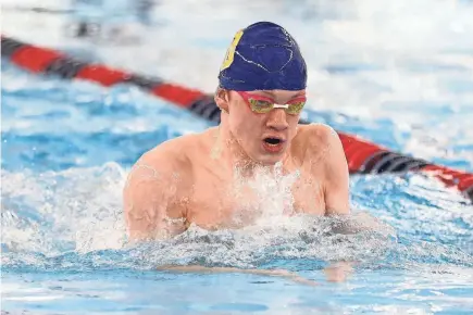  ?? CHAD WEAVER/SOUTH BEND TRIBUNE ?? Christophe­r Bartmess of South Bend Riley competes in the 100-Yard Breaststro­ke during the NIC Boys Swimming Finals on Jan. 28 at the Elkhart Aquatics Center.