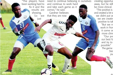  ??  ?? Trey Bennett (centre) from UWI FC tries to go between the Portmore United pair of Sheldon McKoy (left) and Venton Evans (right) during their Red Stripe Premier League football match at the Spanish Town Prison Oval yesterday.