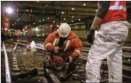  ?? AMTRAK (VIA AP) ?? In this April 6 photo provided by Amtrak, an Amtrak track worker cuts out a railroad tie for replacemen­t at New York’s Penn Station.