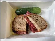  ??  ?? The General Muir’s pastrami sandwich with mustard on double-baked rye comes with a whole half-sour pickle.