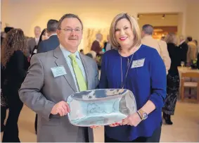  ?? EDDIE MOORE/JOURNAL ?? Terry Laudick, president and CEO of Nusenda Credit Union, and Robin Brulé, head of the Nusenda Foundation, display the Philanthro­pist of the Year award they accepted at an event at the Peters Projects gallery in Santa Fe on Monday night.