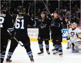  ?? Kelley L Cox / Reuters ?? Adam Burish (37) celebrates with Tommy Wingels (57), Justin Braun (61) and Patrick Marleau (12) after scoring in the second period.