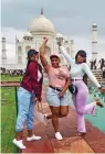  ?? — PTI ?? Foreign tourists pose for a photograph at the Taj Mahal in Agra on Tuesday.