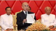  ??  ?? King Norodom Sihamoni reads a document as he attends a senate meeting in Phnom Penh. — Reuters photo