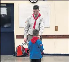  ??  ?? ■ Above: Ben Brown pictured handing out badges to Beavers of the 2nd Loughborou­gh unit.