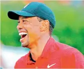  ??  ?? Tiger Woods of the United States reacts during the trophy presentati­on ceremony after winning the Tour Championsh­ip at East Lake Golf Club in Atlanta, Georgia, on Sunday. — AFP