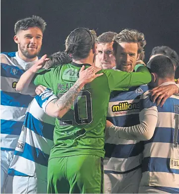  ??  ?? HERO KEEPER: Aidan Mcadams is mobbed by team-mates after shoot-out heroics.