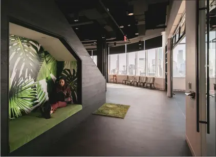  ?? PHOTOS BY JEENAH MOON — THE NEW YORK TIMES ?? An employee works inside an alcove at the Nuts.com headquarte­rs in Jersey City, New Jersey. A host of ancillary spaces, like phone booths and meeting pods, are cropping up, offering employees an escape from their co-workers.