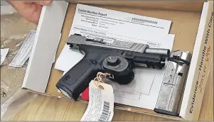  ?? CP PHOTO ?? A 9 mm gun, part of evidence in the trial of William Sandeson, charged in the death of a Dalhousie University student, is shown in a Halifax court on Thursday.