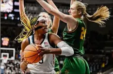  ?? Jessica Hill / Associated Press ?? UConn's Aaliyah Edwards, left, guarded by Vermont's Anna Olson, looks for a shot Saturday. She scored 28 points.