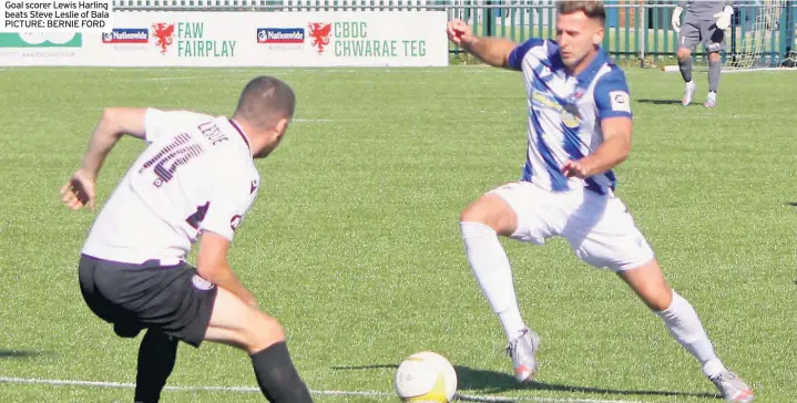  ??  ?? Goal scorer Lewis Harling beats Steve Leslie of Bala PICTURE: BERNIE FORD