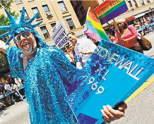  ?? Estate of Gilbert Baker ?? Gilbert Baker marches as the Statue of Liberty, above, in a costume of his own design in New York. Inset: At the Castro Theatre last year. Bottom: Two details from Baker’s outfits.