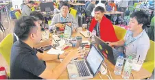  ??  ?? The Thai team hard at work at the Airvolutio­n ‘hackathon’.