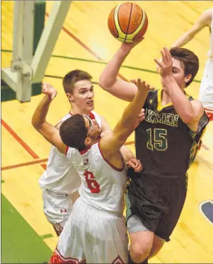  ?? JASON MALLOY/THE GUARDIAN ?? Three Oaks Axemen Ben MacDougall takes a shot over Charlottet­own Rural Raiders forwards Gabe Penalver, front, and Josh Bourque Tuesday during the Prince Edward Island School Athletic Associatio­n Domino’s senior AAA boys’ basketball final at UPEI.