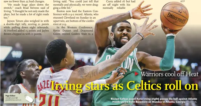  ??  ?? Boston Celtics guard Kyrie Irving (right) passes the ball against Atlanta Hawks guard Kent Bazemore on Monday in Atlanta, Georgia.