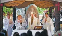  ?? Morgan Timms/The Taos News ?? Priests and deacons begin communion during closing mass for the Pilgrimage for Vocations on Saturday (June 8) at El Santuario de Chimayó.