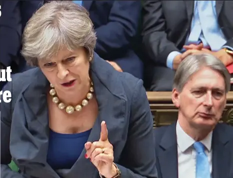  ??  ?? Pearls of wisdom: Chancellor Philip Hammond watches Theresa May in the Commons yesterday