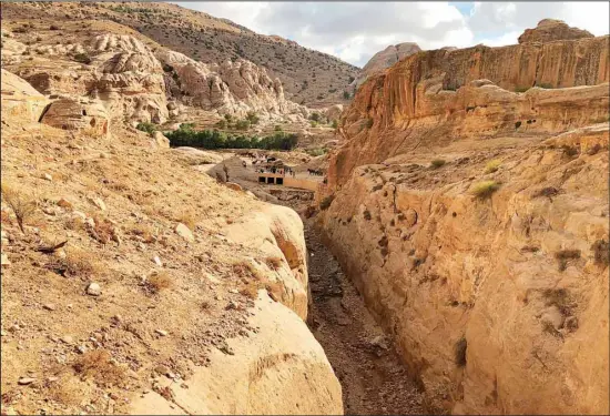  ?? Degradatio­n. (AP) ?? A dam built in the 1960s by the Department of Antiquitie­s, and the ancient Mudlim tunnel, both built to protect the area from flooding, in Petra, Jordan, on Nov. 15, 2018. Efforts to restore damaged but once fertile land in Jordan’s desert is sprouting hope for one of the world’s most water-scarce nations, as a land assessment report on April 27, 2022 warns about the effects of