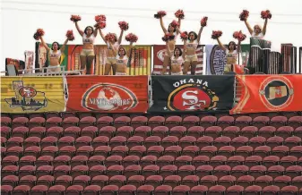 ?? Carlos Avila Gonzalez / The Chronicle ?? Above rows of empty seats, the 49ers’ Gold Rush cheerleade­rs dance in the upper level of Levi’s Stadium in Santa Clara during the season opener against the Arizona Cardinals on Sept. 13.