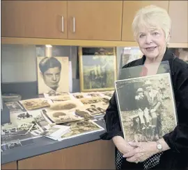  ?? PHOTOS BY RICH PEDRONCELL­I — THE ASSOCIATED PRESS ?? Diane Capone holds a copy of a photograph of her father, Albert “Sonny” Capone, as a young boy and her grandfathe­r Al Capone on Wednesday in Sacramento.