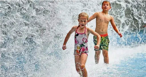  ??  ?? Cooling off: Children playing in the Waterfall Playpool at the KLCC Park in Kuala Lumpur.