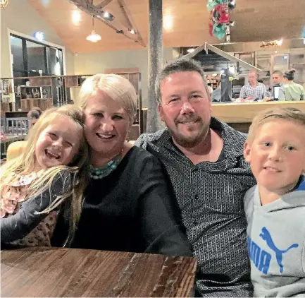  ??  ?? Lou Riches and Andy Davis with their children Layla and Sam. Davis remains in intensive care after a December dirt biking accident.