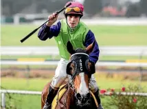  ?? PHOTO: ANDY JACKSON/FAIRFAX NZ ?? Longchamp’s jockey Timothy Johnson salutes after winning last season’s Opunake Cup.