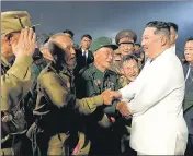  ?? AP ?? Kim Jong-un (right) shakes hands with war veterans during a ceremony in Pyongyang, North Korea on Wednesday.