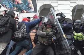  ?? ROBERTO SCHMIDT/ AFP VIA GETTY IMAGES ?? Police push back Capitol rioters.