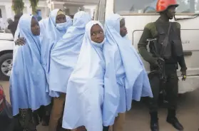  ?? Sunday Alamba / Associated Press ?? Some of the students who were abducted by gunmen from a government school wait for a medical checkup after their release in Gusau, Nigeria.