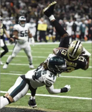  ?? BILL FEIG — THE ASSOCIATED PRESS ?? Saints receiver Michael Thomas (13) pulls in a touchdown reception against Eagles cornerback Cre’von LeBlanc (34) in the second half Sunday in New Orleans.