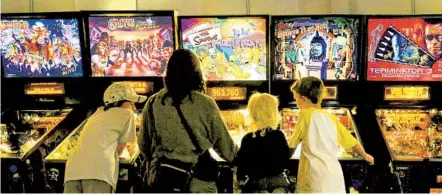  ?? JIM SCHELBERG PINBALL HALL OF FAME PHOTOS ?? Visitors at the Pinball Hall of Fame in Las Vegas. “If a museum closes, it’s likely to close forever — and its collection­s, stories, expertise might be lost forever too,” says Laura Lott, president and CEO of the American Alliance of Museums.