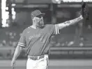  ?? ZACHARY BONDURANT / USA TODAY SPORTS ?? Team Canada pitcher John Axford celebrates with the crowd after an inning against Team Great Britain at Chase Field on Sunday.