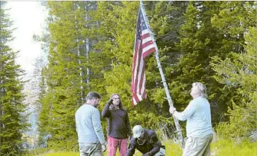  ?? Gravitas Ventures / CNN Films ?? FORMER GREEN BERETS honor the flag during a camping trip shown in Greg Barker’s documentar­y film. “Legion of Brothers” shows thoughtful, contained men who talk with a marked lack of bravado about combat.