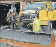  ?? DAVID JALA/CAPE BRETON POST ?? Equipment operator Neil Walsh checks to make sure a snowplow truck is in proper working at the Nova Scotia Department of Transporta­tion depot in Sydney River on Sunday. Environmen­t Canada has issued a blizzard warning for the entire province with the...