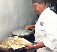  ??  ?? Head Chef Claudette Tenn dishes out her tasty steamed fish.