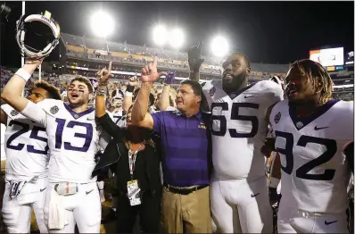  ?? AP/TYLER KAUFMAN ?? Ed Orgeron (middle) was a graduate assistant at the University of Arkansas from 1986-87 and has had head coaching stops at Ole Miss and Southern Cal before taking over at LSU. The Tigers face the top-ranked Alabama Crimson Tide on Saturday.