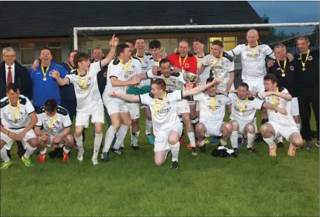  ??  ?? Champions Real Tubber celebrate after following their Division One victory with another title, the Northwest Hospice Shield in Ray MacSharry Park on Saturday night.