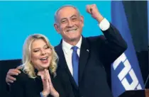  ?? ?? BENJAMIN NETANYAHU and his wife, Sara, at the Likud party headquarte­rs in Jerusalem on
November 2, after exit polls made it clear that he would be Prime Minister yet again. He first became Prime Minister in 1996.