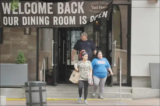  ??  ?? People exit a reopened restaurant Friday, May 15, 2020 in downtown Kansas City, Mo. Restaurant­s were allowed to serve dine-in customers today for the first time since mid-March when the
city issued stay-at-home orders to stream the spread of COVID-19. (AP)