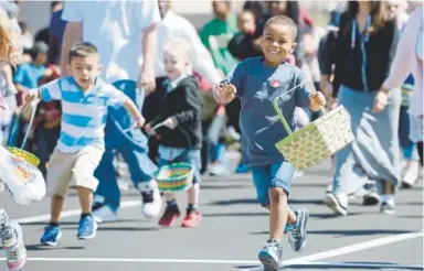  ??  ?? Kids dash for eggs at The Potter’s House of Denver egg hunt.