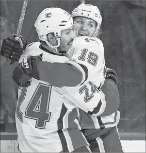  ?? AP PHOTO/KATHY WILLENS ?? Calgary Flames defenseman Travis Hamonic (24) celebrates with Calgary Flames left wing Matthew Tkachuk (19) after Tkachuk scored the game-winning goal against New York Islanders goaltender Jaroslav Halak during the third period of an NHL hockey game in...