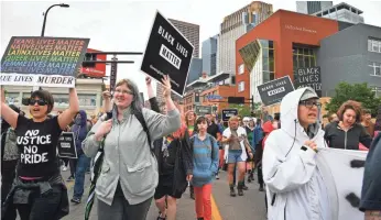  ?? GLEN STUBBE, STAR TRIBUNE, VIA AP ?? Black Lives Matter participan­ts protest the inclusion of police officers in the Twin Cities Pride Parade along Hennepin Avenue at the start of the event in Minneapoli­s on Sunday.