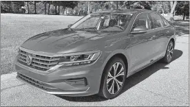  ?? MARK PHELAN/DETROIT FREE PRESS/TNS ?? The redesigned 2020 Volkswagen Passat, right, has an accommodat­ing trunk, left, that makes it easy to load bulky objects.