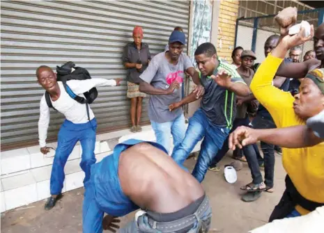  ?? PHOTO: ?? A mob attacks a Nigerian migrant outside a church in Pretoria, South Africa last week. Reuters