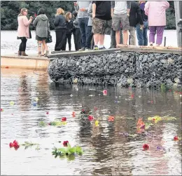  ?? SUBMITTED ?? Flowers set adrift in memory of Luke Cooper, the North West River man who is presumed dead after his canoe capsized July 15, float on the water by the boat launch in North West River on Aug. 15.