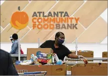  ?? JOHN BAZEMORE / ASSOCIATED PRESS ?? Food banks have ramped up their output during the coronaviru­s pandemic to meet an explosion of need from families facing financial hardship.
