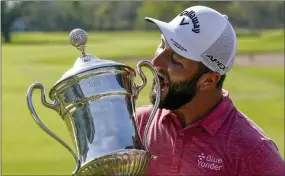  ?? EDUARDO VERDUGO — THE ASSOCIATED PRESS ?? Jon Rahm, of Spain, celebrates with the championsh­ip trophy after winning the Mexico Open at Vidanta, in Puerto Vallarta, Mexico, Sunday, May 1, 2022.